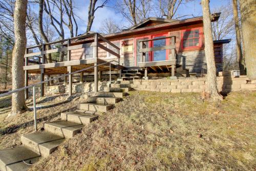a home with stairs leading up to it at Cozy Cabin with Private Dock on Fifth Crow Wing Lake in Nevis