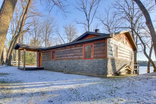 a small log cabin in the middle of the woods at Cozy Cabin with Private Dock on Fifth Crow Wing Lake in Nevis