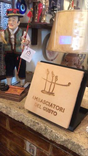 a sign for a masestationlection del civico on a counter at Hotel Villa Pina Antico Francischiello in Massa Lubrense
