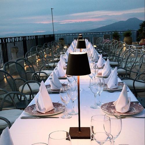 a long table with wine glasses and napkins on it at Hotel Villa Pina Antico Francischiello in Massa Lubrense