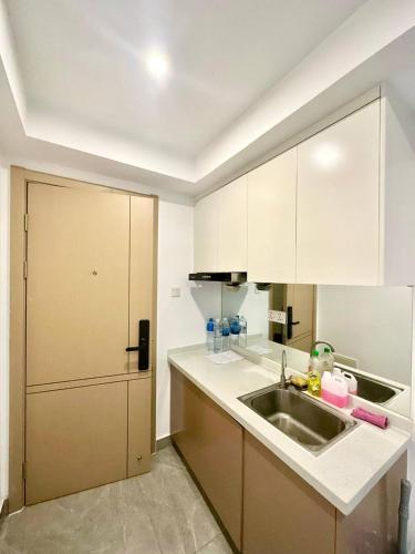 a kitchen with a sink and a refrigerator at Riverside Apartment in Phnom Penh