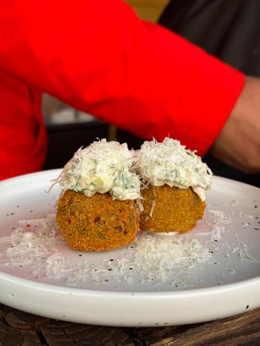 two food items on a plate on a table at Bonanza Terra in Rukliai