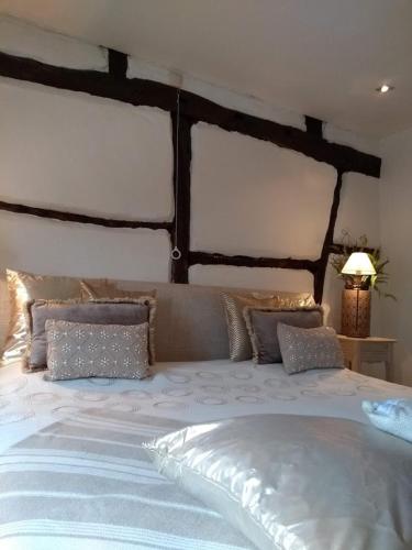 a bedroom with a large bed with pillows at B&B Hof van Vervoering in Voeren