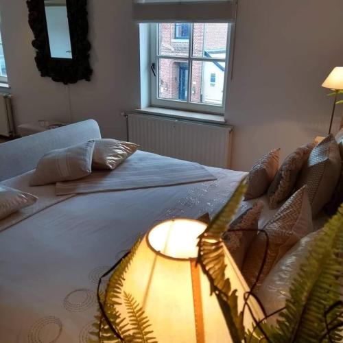 a bedroom with a bed with a lamp on it at B&B Hof van Vervoering in Voeren