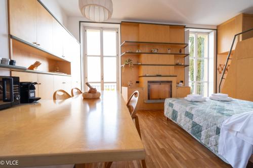 a living room with a table and a fireplace at La Casa di Anna in Varenna