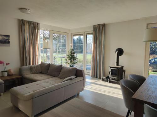 a living room with a couch and a fireplace at Domek v Podještědí in Januv Dul