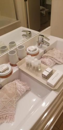 a white bathroom with a sink and a mirror at B&B Hof van Vervoering in Voeren