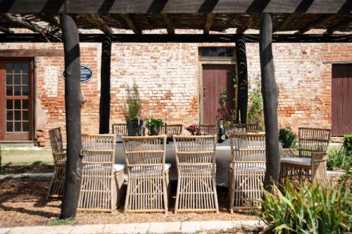 a group of chairs sitting under a pergola at Lawsons Estate on Macquarie Farm in Brewongle