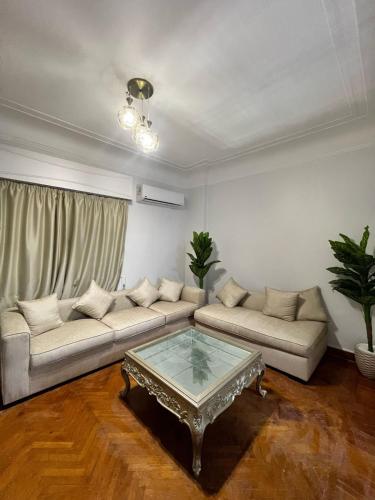 a living room with a couch and a coffee table at Triple Garden Studios and apartments in Cairo