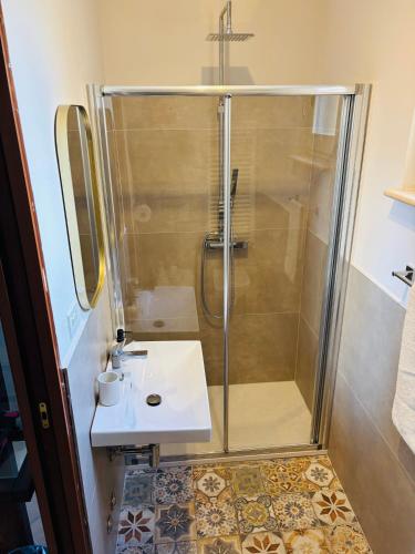 a bathroom with a shower and a sink at Al Belvedere Apartment II in Atri
