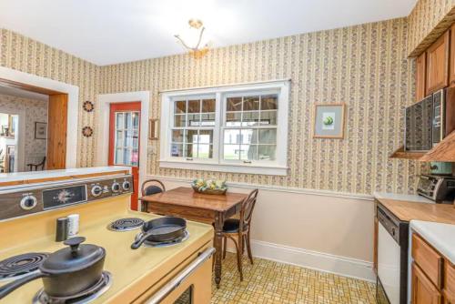 a kitchen with a table and a stove top oven at Briarstone Inn Unit 2 in Galena