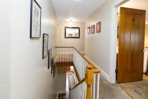 a hallway with a staircase with a wooden door at Briarstone Inn Unit 2 in Galena