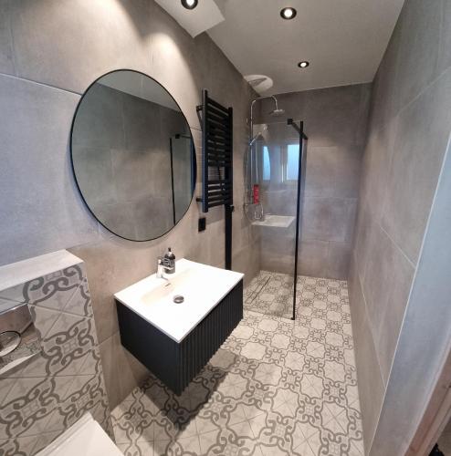 a bathroom with a sink and a mirror at Apartment- fjord view, big terrace, close to Moa in Ålesund