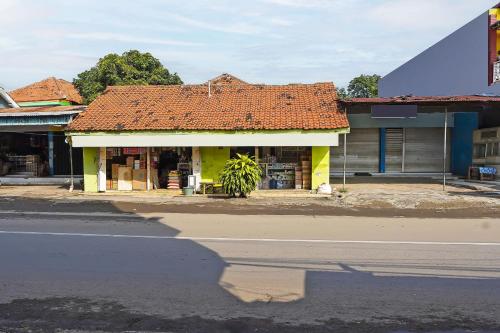 a building with an orange roof on the side of a street at Hotel O Salsabila Homestay in Pasuruan