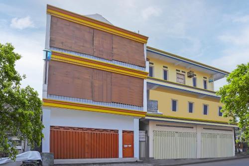a tall building with orange and yellow at Hotel O Salsabila Homestay in Pasuruan