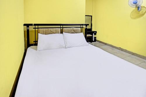TanjungkarangにあるHotel O Kos Agi Mataram Near Masjid Hissoh Al-Fahamの大型ベッド(白い枕付)