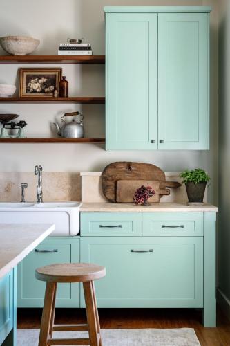 a kitchen with white cabinets and a sink at Lawsons Estate on Macquarie Farm in Brewongle