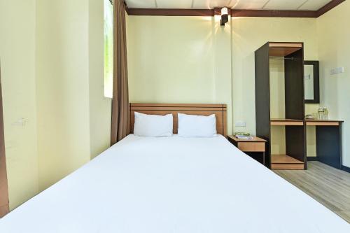 a bedroom with a large white bed with a mirror at Hotel O Pendang Lake Formerly D Jiwa in Pendang