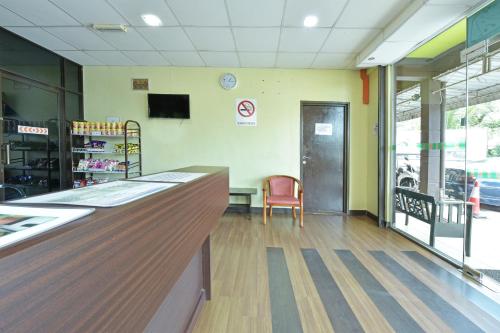 a waiting room with a counter and a chair at Hotel O Pendang Lake Formerly D Jiwa in Pendang