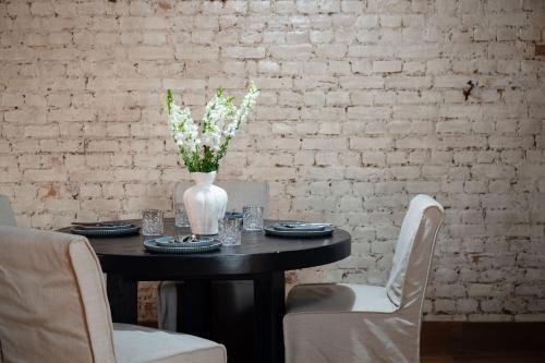 a table with a vase of flowers on it at Lawsons Estate on Macquarie Farm in Brewongle