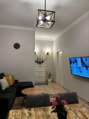 a living room with a couch and a tv at ELAY Apartments in Baku