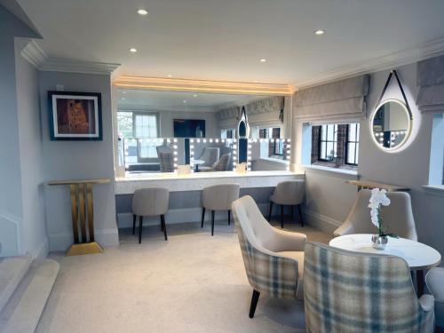 a waiting room with a table and chairs at Western House Hotel At Ayr Racecourse in Ayr