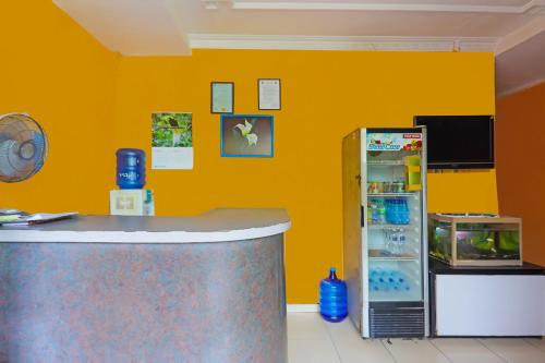 a kitchen with a counter and a refrigerator at Hotel O Faraas Homestay Syariah in Nongsa