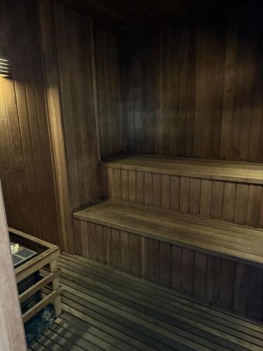a wooden sauna with wooden steps in a room at Dream Flat Pinheiros in Sao Paulo