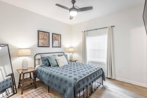 a bedroom with a bed and a ceiling fan at The Arches Walk To Western Ave District in Oklahoma City