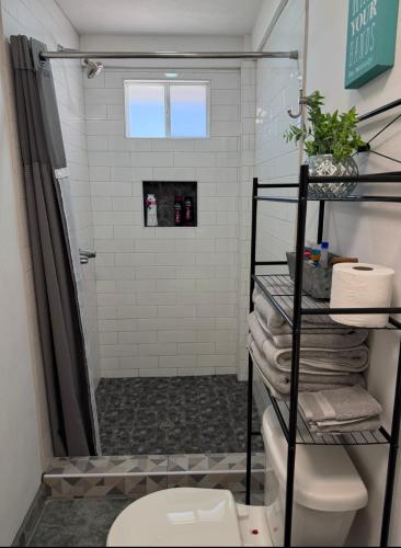 a bathroom with a shower and a toilet at Seaside Adventure Lodging in Ensenada