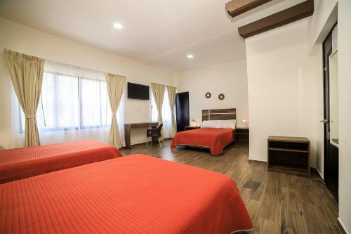 Postel nebo postele na pokoji v ubytování Capital O Hotel Boutique Las Torres