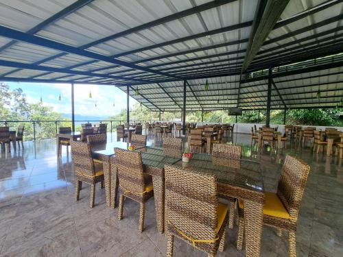 a dining room with tables and chairs with a view at Tambo Eco Hotel in La Vega