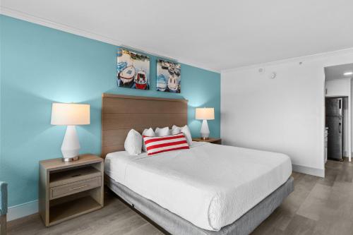 a bedroom with a large bed and two night stands at Compass Cove in Myrtle Beach
