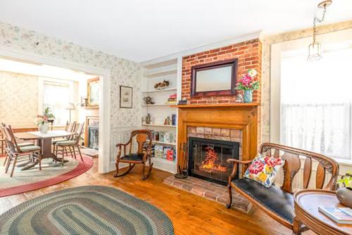 a living room with a fireplace and a table at Briarstone Inn Unit 3 in Galena