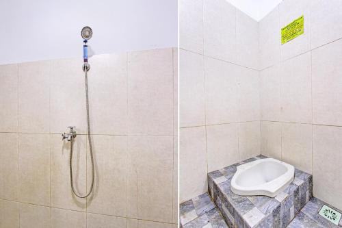 a bathroom with a shower with a toilet at Hotel O Pacar Guesthouse in Pekalongan