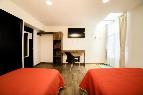 Postel nebo postele na pokoji v ubytování Capital O Hotel Boutique Las Torres
