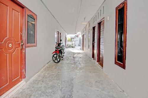 a motorcycle parked in a hallway of a building at Hotel O Teguh Homestay Syariah in Parit
