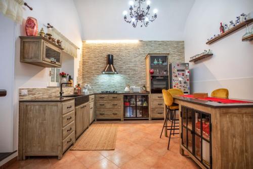 a large kitchen with wooden cabinets and a counter at Casale il tramonto in Massa Lubrense