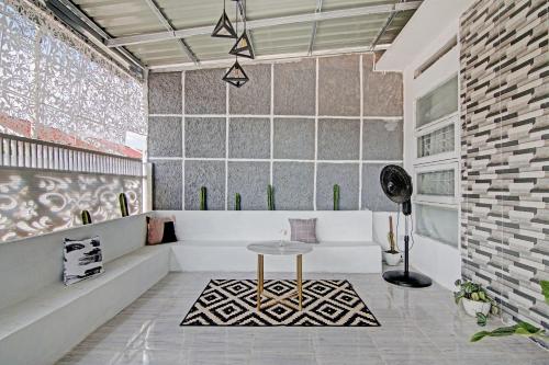 a living room with a table and a couch at Hotel O Teguh Homestay Syariah in Parit