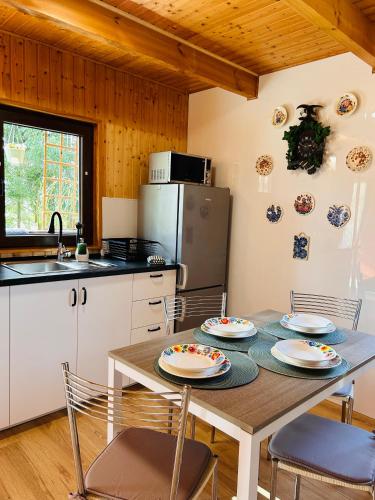 a kitchen with a table with plates on it at Domek Natura in Rybno