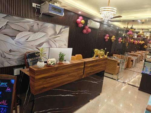 a reception desk in a restaurant with a giant bed at Hotel Royal Plaza in Rishīkesh