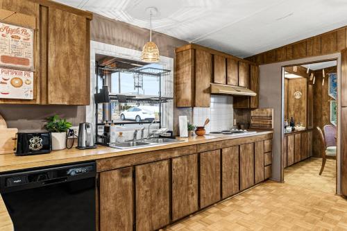 a kitchen with wooden cabinets and a sink at Harry Potter and the Scenic Escape in Yakima