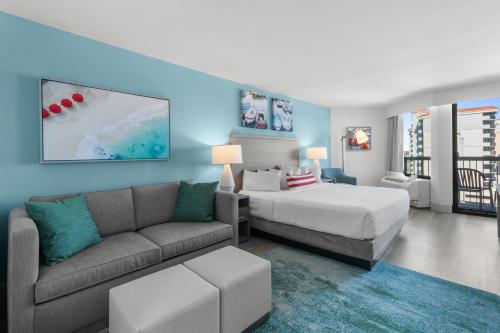 a hotel room with a bed and a couch at Compass Cove in Myrtle Beach
