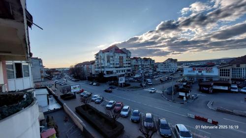 a city street with cars parked in a parking lot at Targu Jiu Central Apartment - Free Parking & Self Check-In in Târgu Jiu