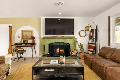 a living room with a couch and a fireplace at Tranquil Gardens Soaking Pool Ember Stone in Yucca Valley