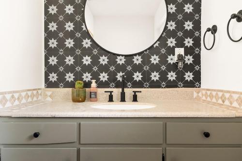 a bathroom with a sink and a mirror at Tranquil Gardens Soaking Pool Ember Stone in Yucca Valley
