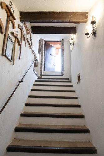 a stairway leading up to a window in a building at GiuMa Tuscany Historic Country House with Roof Terrace near Saturnia Spa in Montemerano