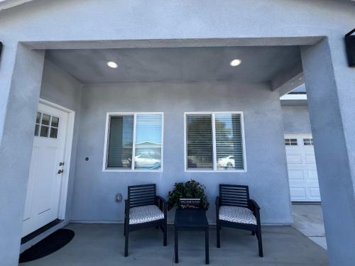 a porch with two chairs and a table and two windows at Vacation home in Westminster