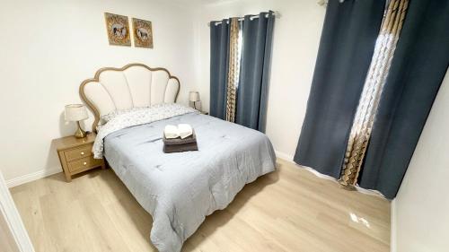 a bedroom with a bed with two candles on it at Newly renovated, warm home with 4 bedrooms, 14 miles from Disney in Whittier