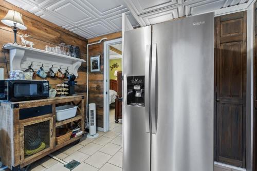a kitchen with a stainless steel refrigerator at Under the Eaves Inn at Zion National Park in Springdale